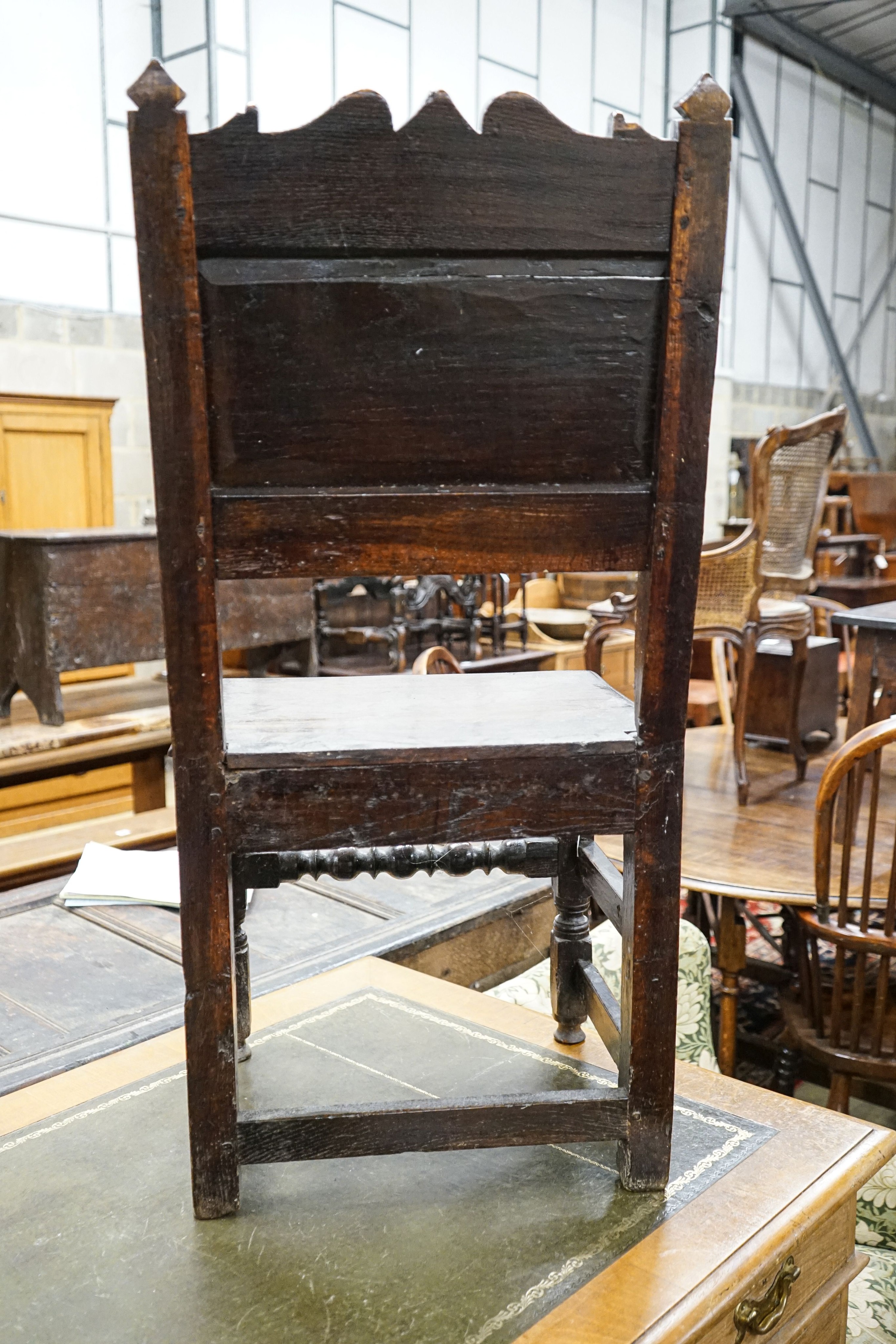 A 17th century oak back stool, with lozenge and foliate carved panelled back and solid seat, on turned and square underframe, width 48cm, depth 40cm, height 97cm, with receipt from Swan Antiques dated 2002